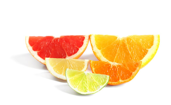 Delicious citrus fruits slices on white background