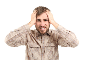 Young man suffering from headache on white background