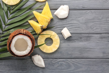Fototapeta na wymiar Pineapple and coconut on wooden background