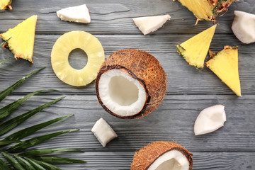 Pineapple and coconut on wooden background