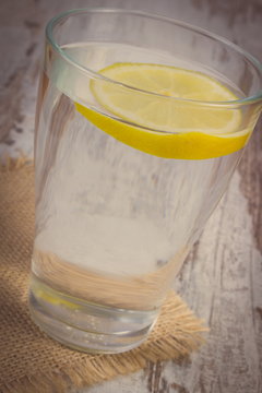 Vintage photo, Glass of clean water with slice of lemon, cold lemonade