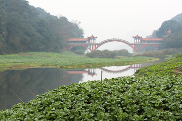 Fototapeta premium Ancient traditional red bridge in the fog in Leshan - China