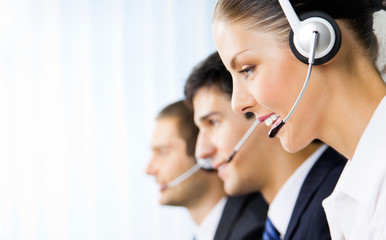 Three support phone operators at workplace