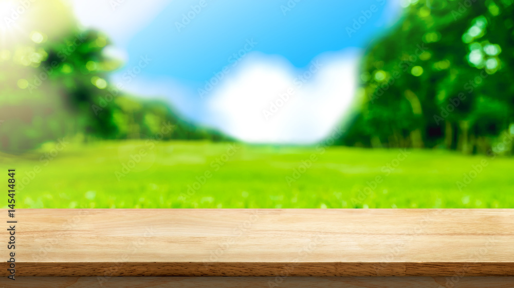Poster Empty brown wooden table top with blurred green fields at park, Mock up template for display or montage of your design,Banner for advertise of product,panorama view