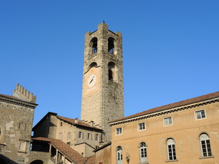Fototapeta na wymiar Bergamo - Old city (Città Alta). Landscape on the the ancient Administration Headquarter called Palazzo della Ragione and the clock tower called Il Campanone