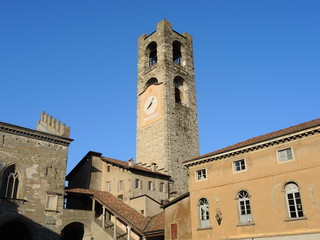 Fototapeta na wymiar Bergamo - Old city (Città Alta). Landscape on the ancient Administration Headquarter called Palazzo della Ragione and the clock tower called Il Campanone