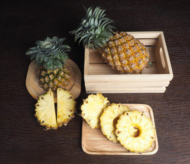Fototapeta na wymiar pineapple and pineapple slide in wood box 