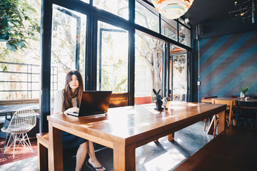 Student women use laptop computer in modern art cafe