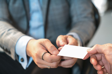 Closeup portrait of two successful business executive exchanging business card - Powered by Adobe