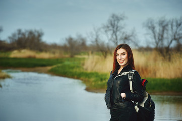 Beautiful redhead girl on a spring walk . Hiking