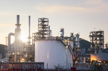 Fototapeta na wymiar Natural Gas storage tanks and oil tank in industrial plant at twilight