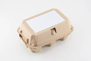 Gordijnen Paper egg box - egg carton on white background © Kittichai