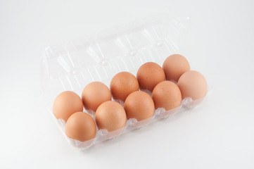 eggs in plastic box on white background