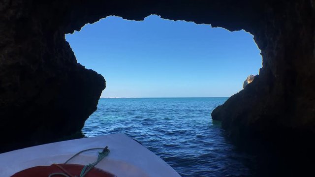 Sailing In Ocean Passing Inside A Rock Formation POV. POV boat scene floating into the ocean going straight to a rock cave