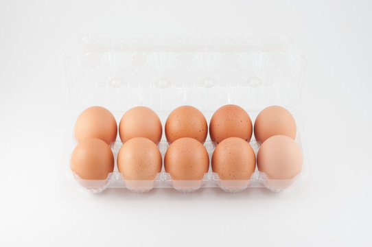 eggs in plastic box on white background