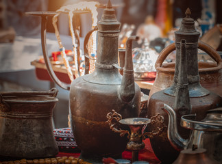 old copper household goods on counter in sunday flea market. Antique bazaar