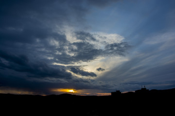 Sunset with partly cloudy sky. Dramatic sky - obrazy, fototapety, plakaty