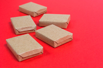 Boxes in craft paper on red background