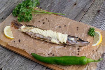 Baked pike wooden on the table