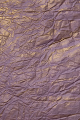 The texture of crumpled paper purple and gold