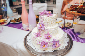 wedding cake stands on the table the couple