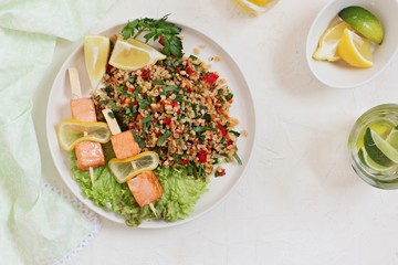 Tabbouleh and salmon skewerws.Traditional bulgur salad with vegetables and herbs. Selective focus 