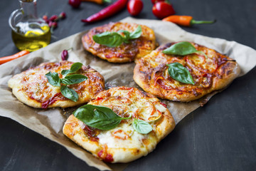 Mini pizzas with cheese, salami and spices freshly baked