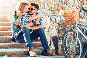 Couple riding on bicycles and having fun