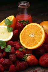 several bottles with fruit and berry juices smoothies and milksh