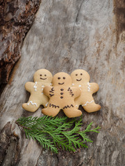 Happy gingerbread people on aged wood