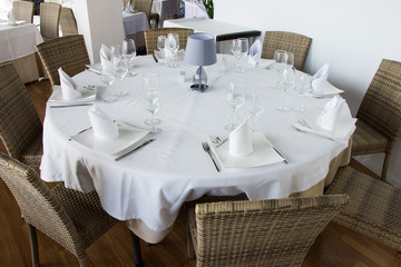 Covered white table prepared for serving dishes
