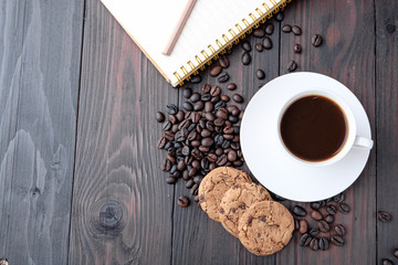 Coffee cup and coffee beans on wooden background