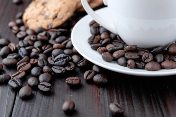 Coffee cup and coffee beans on wooden background