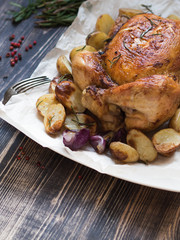 Roast chicken and various vegetables on a white plate