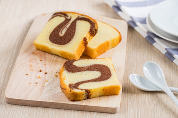 Butter cake sliced on wooden plate