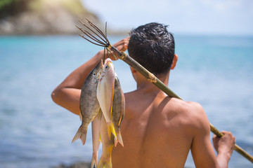 Fishing backgrounds. Young man hold big carp in his hands. - obrazy, fototapety, plakaty