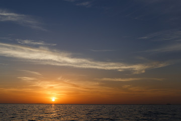 Naklejka na ściany i meble Photography of sunset by sea