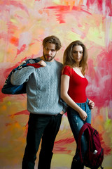 Pretty girl with backpack and bearded man with bag