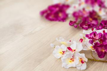White and purple orchids on wooden surface