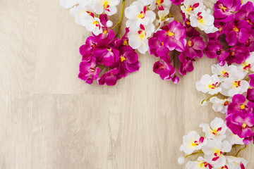 White and purple orchids on wooden surface