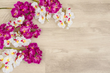 White and purple orchids on wooden surface