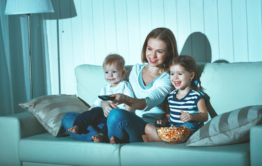 Obraz premium Family mother and children watching television at home
