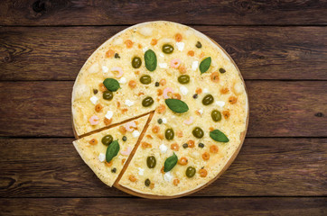 Italian seafood pizza at wood background