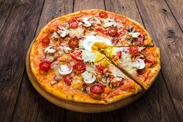 Delicious pizza with mushrooms, bacon and egg
