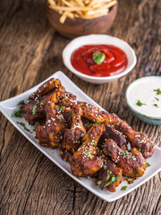 Chicken wings. Fried chicken wings in white bowl garlic dressing ketchup and potato fries.