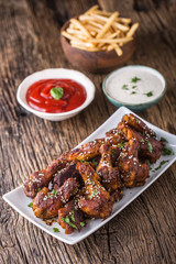 Chicken wings. Fried chicken wings in white bowl garlic dressing ketchup and potato fries.