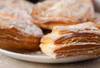 Macro shot of puff pastries in a white plate