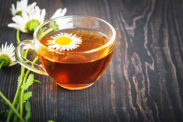 Chamomile tea in a transparent cup closeup. The concept of herbal medicine.