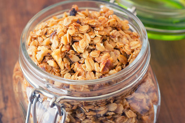 Fresh granola, muesli in a glass jar. copy space.Organic oat,almond and sunflower seeds