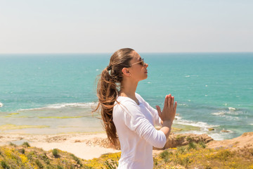 Fototapeta na wymiar Young woman yoga on the sea beach